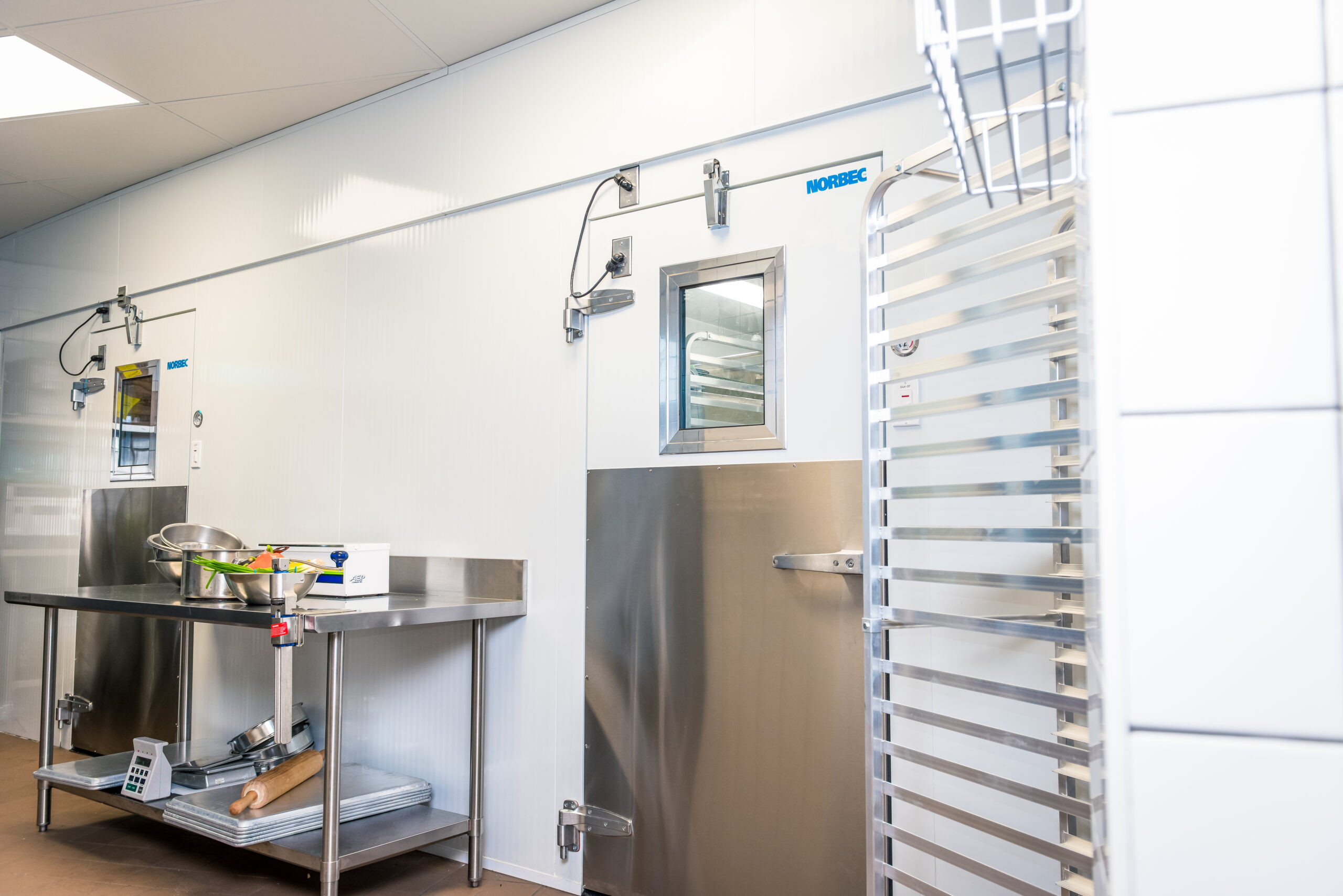 A walk-in cooler door in a commercial kitchen.